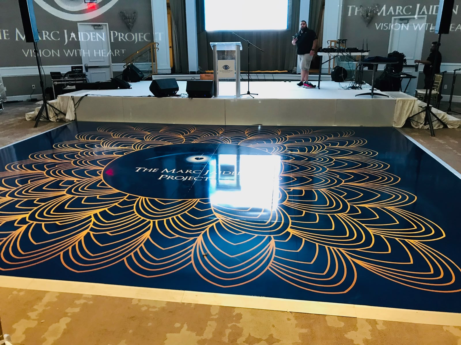 Custom navy blue and gold mandala monogram dance floor wrap installed for charity gala in Miami FL