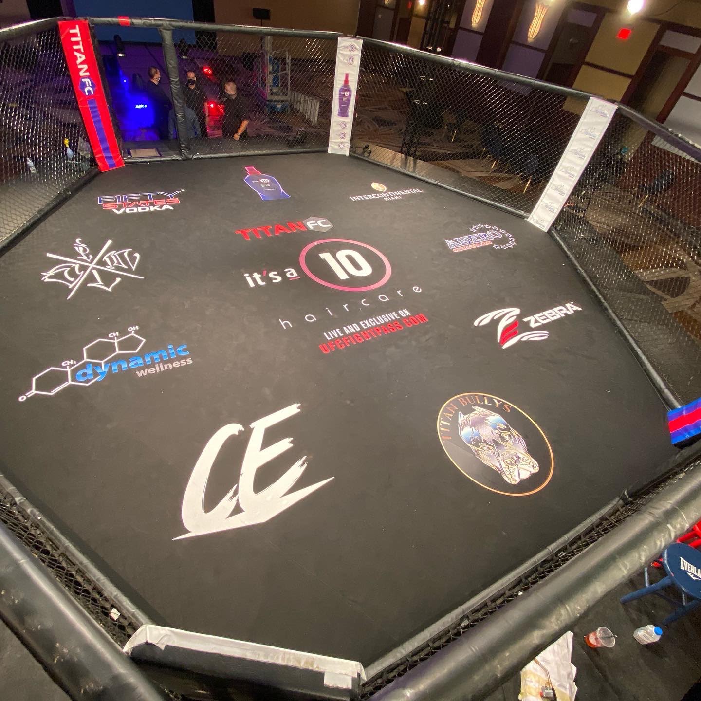 Titan FC professional MMA cage canvas floor wrap and sponsor logo graphics installation at InterContinental Miami FL