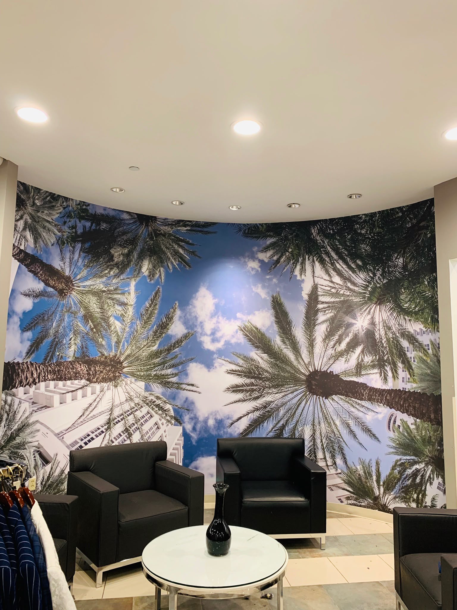 Architectural curved lobby wall wrap mural with tropical Miami palm trees and blue sky perspective in Miami Beach FL