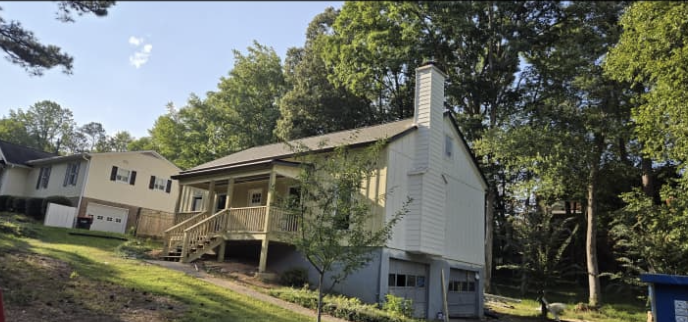 Completed exterior vertical siding, chimney trim, and front porch build by Quality Painting & Home Repairs in Rome GA