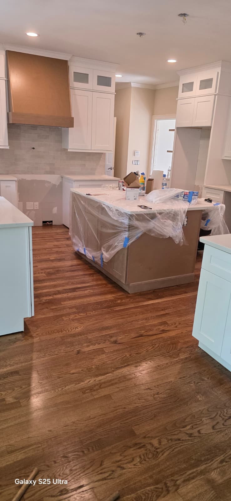 Warm oak hardwood floor refinishing and protective topcoat in kitchen remodel in Rome GA