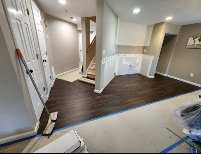 Dark wood flooring installation, door trim, and interior painting project in Cartersville GA