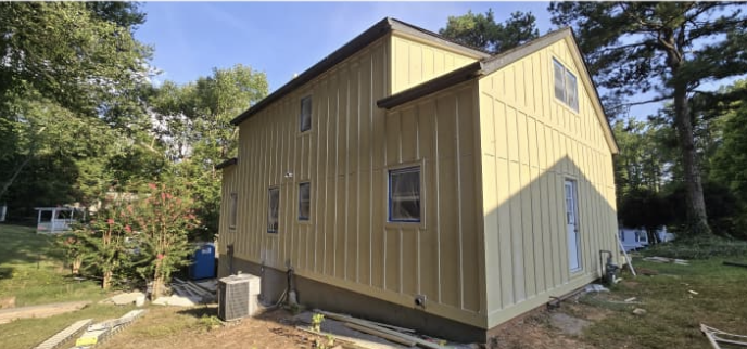 Completed exterior board and batten siding installation and exterior paint finish by Quality Painting & Home Repairs in Hiram GA