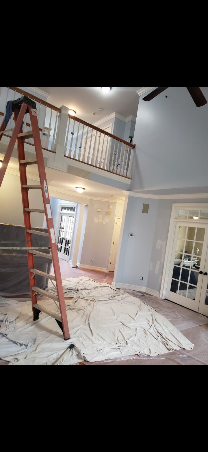 Two-story grand entryway interior wall painting, stair spindle prep and French door trim in Cartersville GA