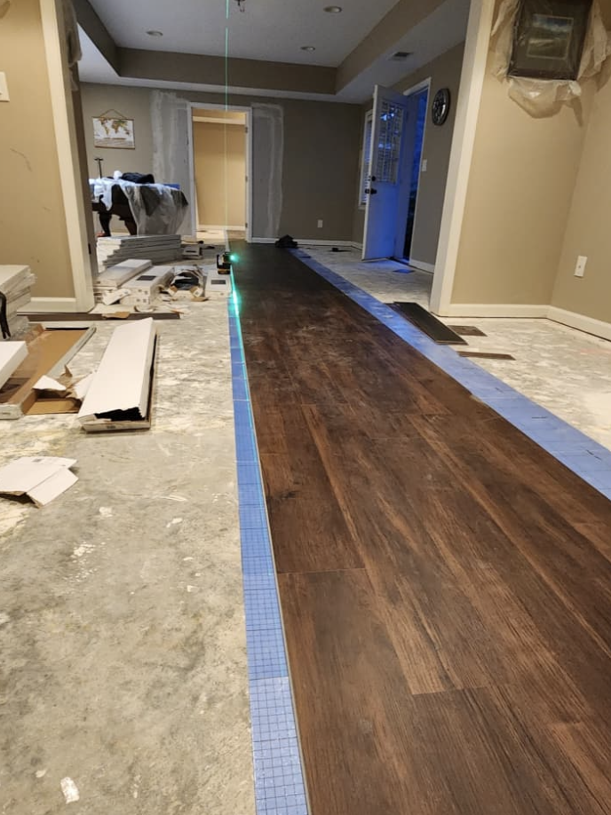 Laser alignment and luxury hardwood plank flooring installation by Quality Painting & Home Repairs in Cedartown GA