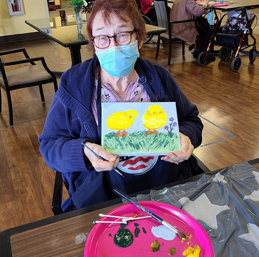 Resident enjoying a painting activity