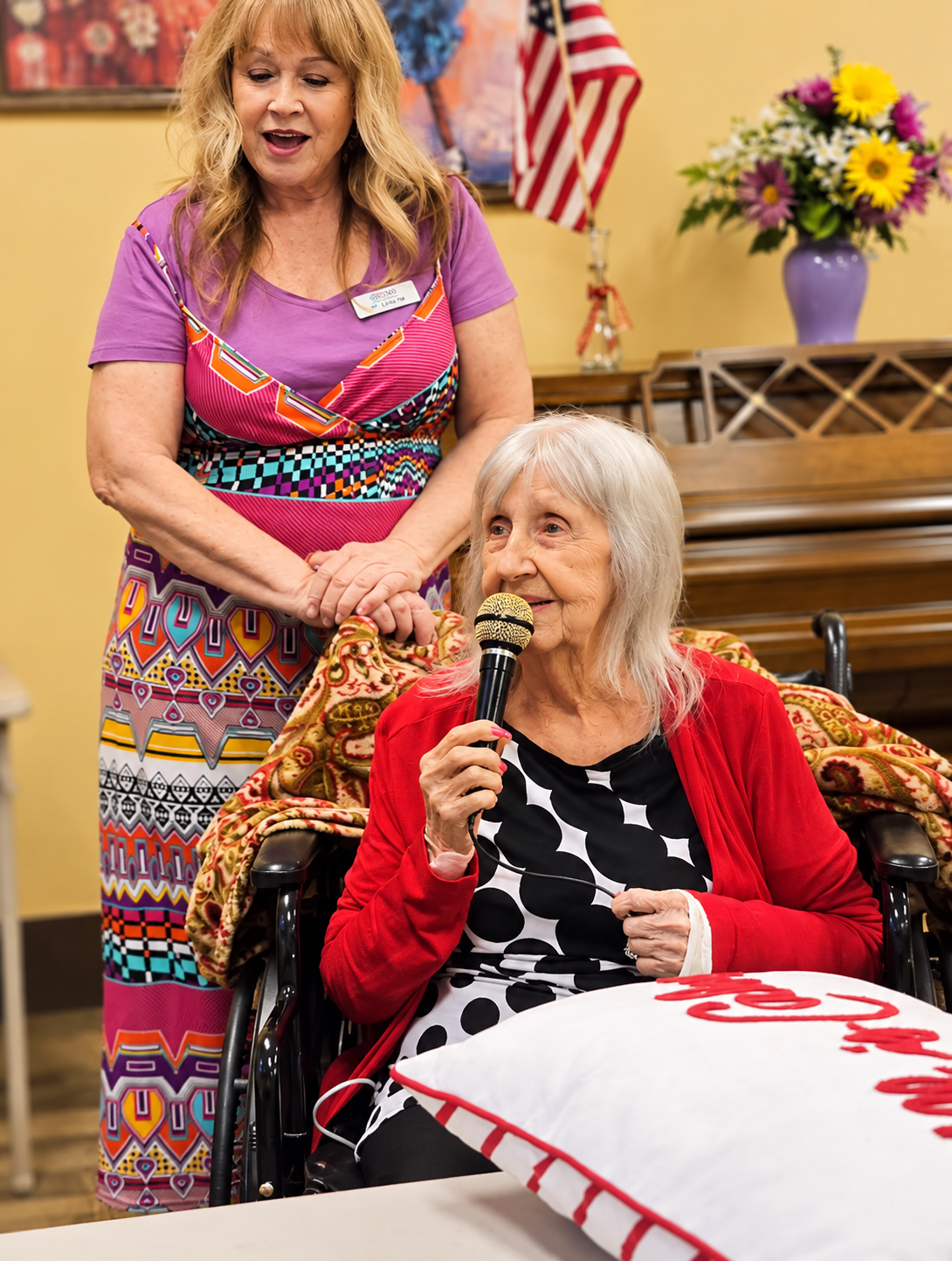 Speech and vocal engagement activity with resident singing into microphone supported by Seasons staff
