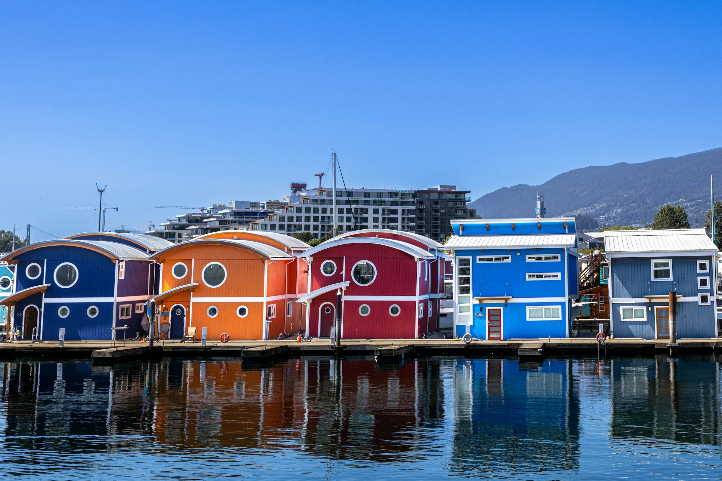 North Vancouver marina with floating homes and coastal mountains