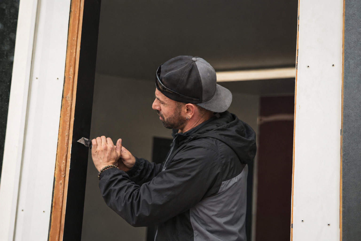 Julian Martinez, Owner of Window Boise, working on a window installation