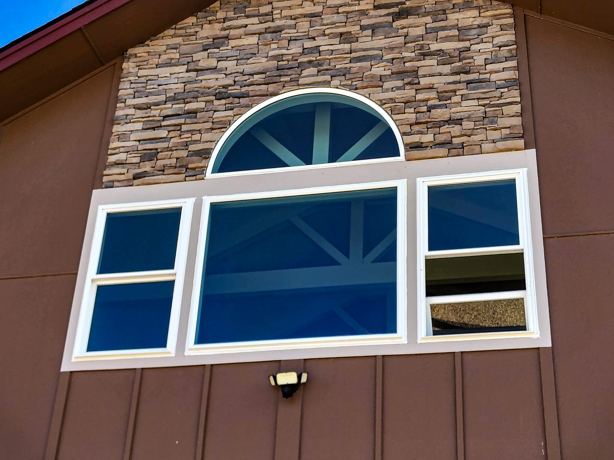 Window Boise custom arched and architectural window installation on stone exterior