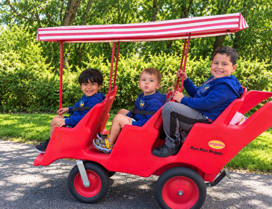 Children enjoying an outdoor walk in the bye-bye buggy on a sunny day in Hyannis