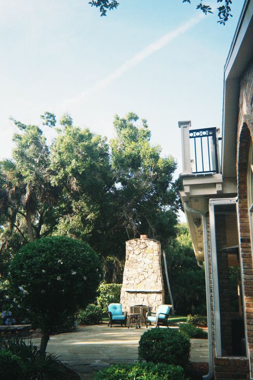 Stone patio area with an outdoor fireplace