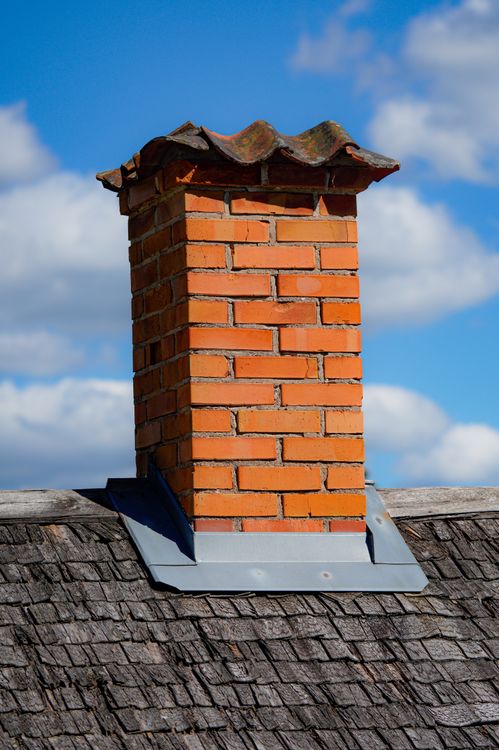 Traditional brick chimney on a residential rooftop