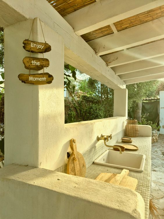 Rustic outdoor kitchen area with wooden and masonry features