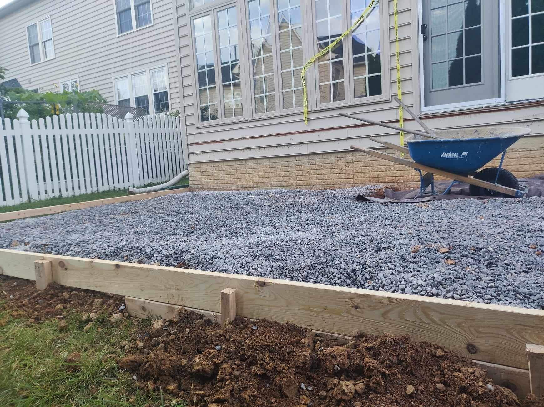 Gravel base preparation with wheelbarrow