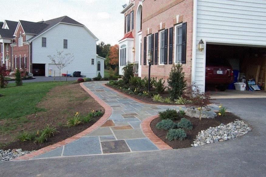 Red brick border and natural stone masonry detail by Lionstone