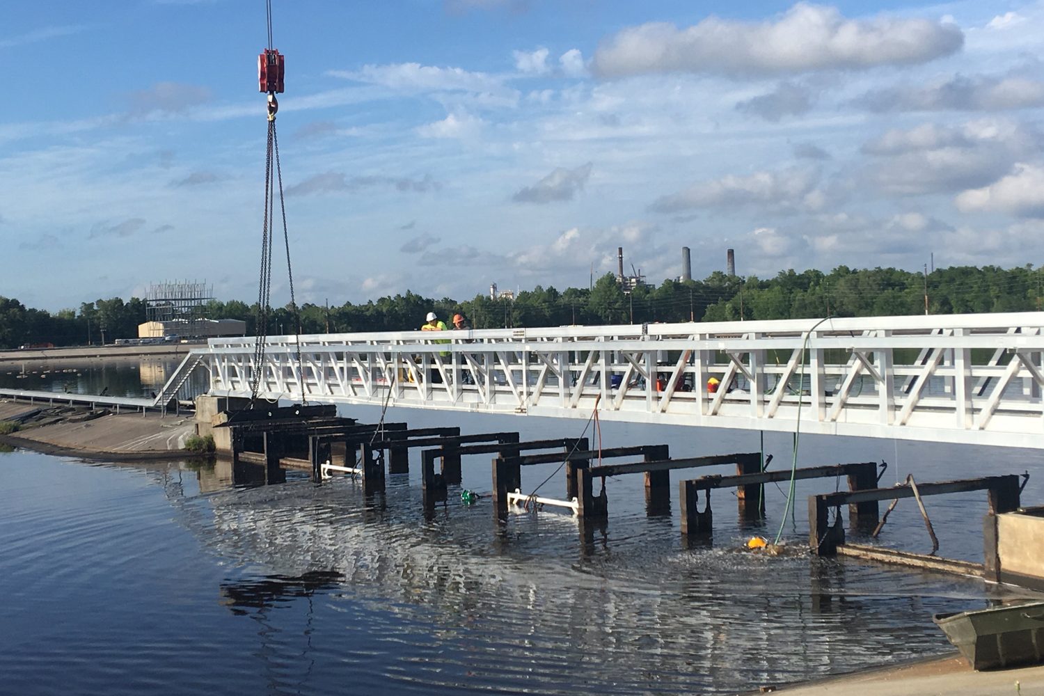 Gate bays and a footbridge at a river dam.