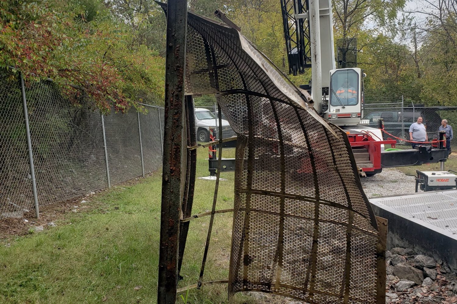 Damaged intake screen lifted out of the water by a crane.