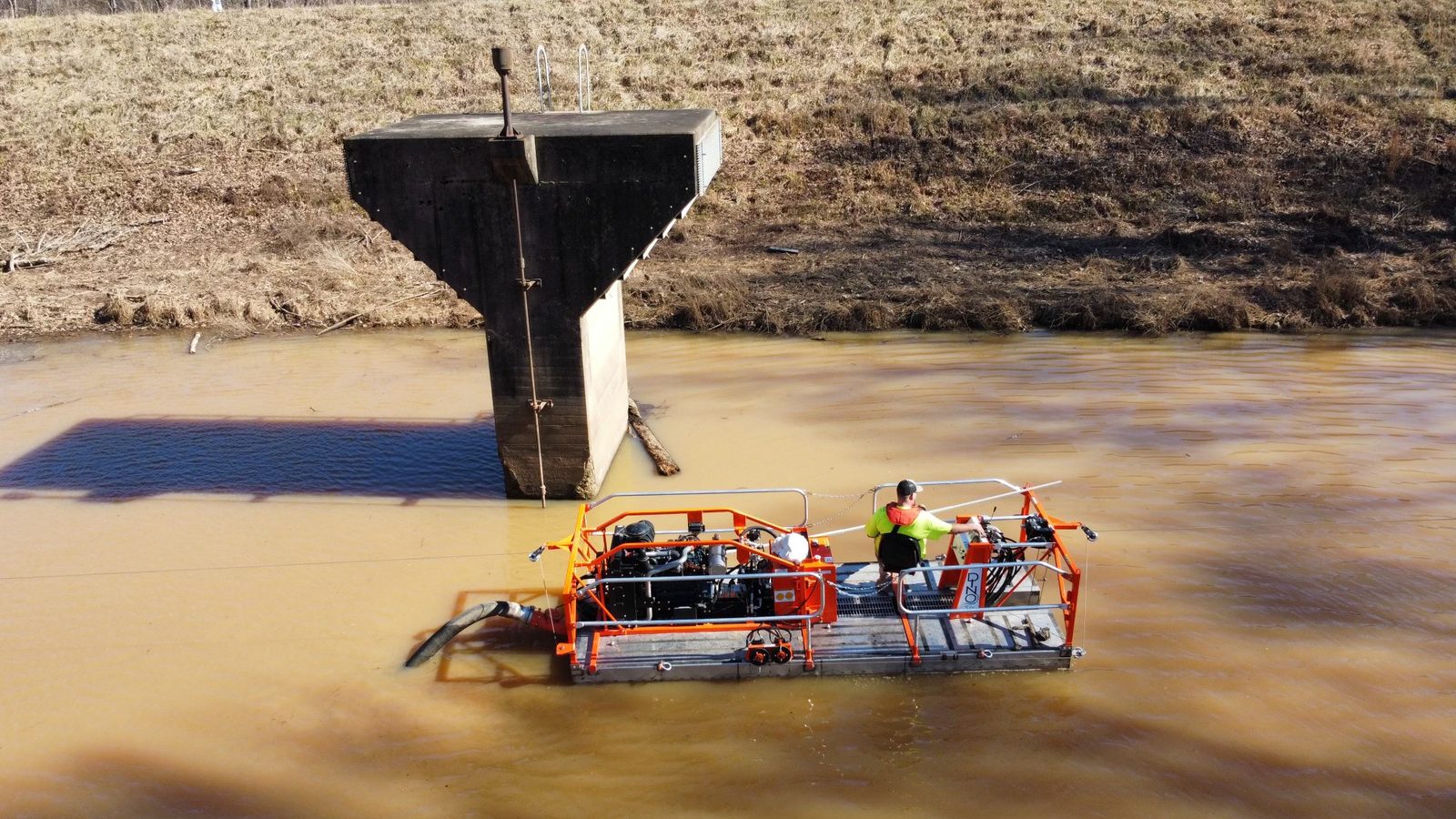 Dredge barge beside an intake tower.
