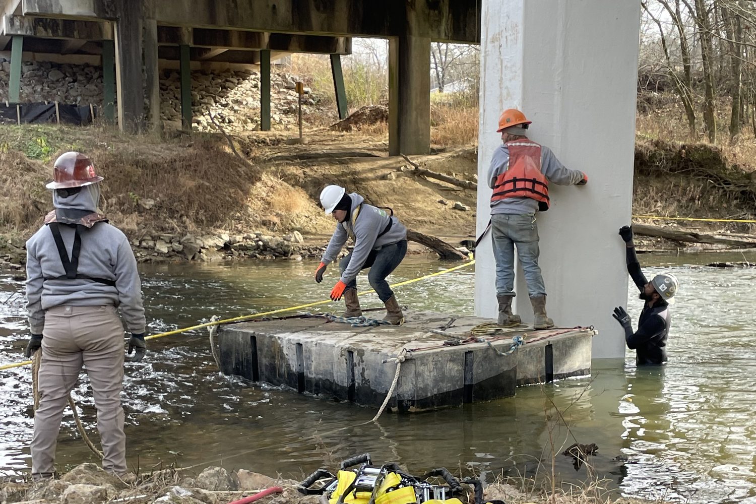 Crew on a floating platform beside a finished pile jacket.