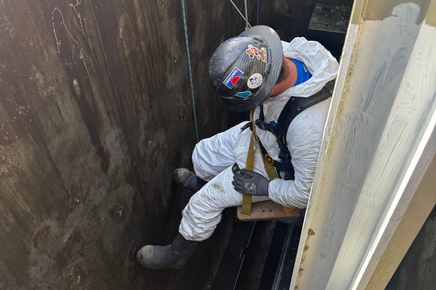 Crew wrapping a shaft for protection during repair work.