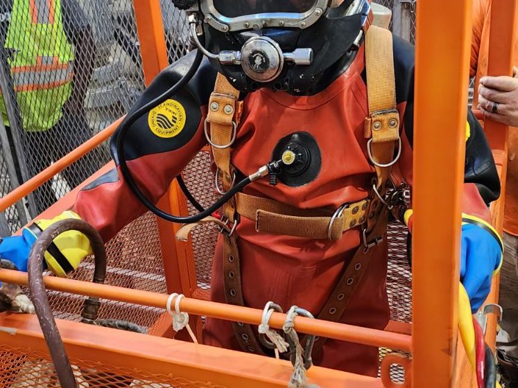 Diver in a man basket ready for a dive.