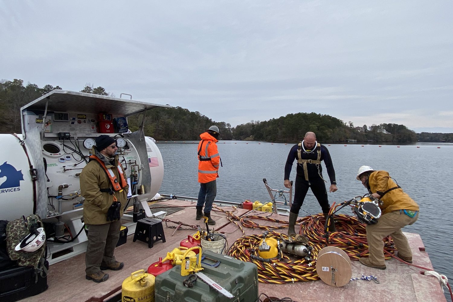 Dive chamber and dive crew on a barge at Lake Tuscaloosa.