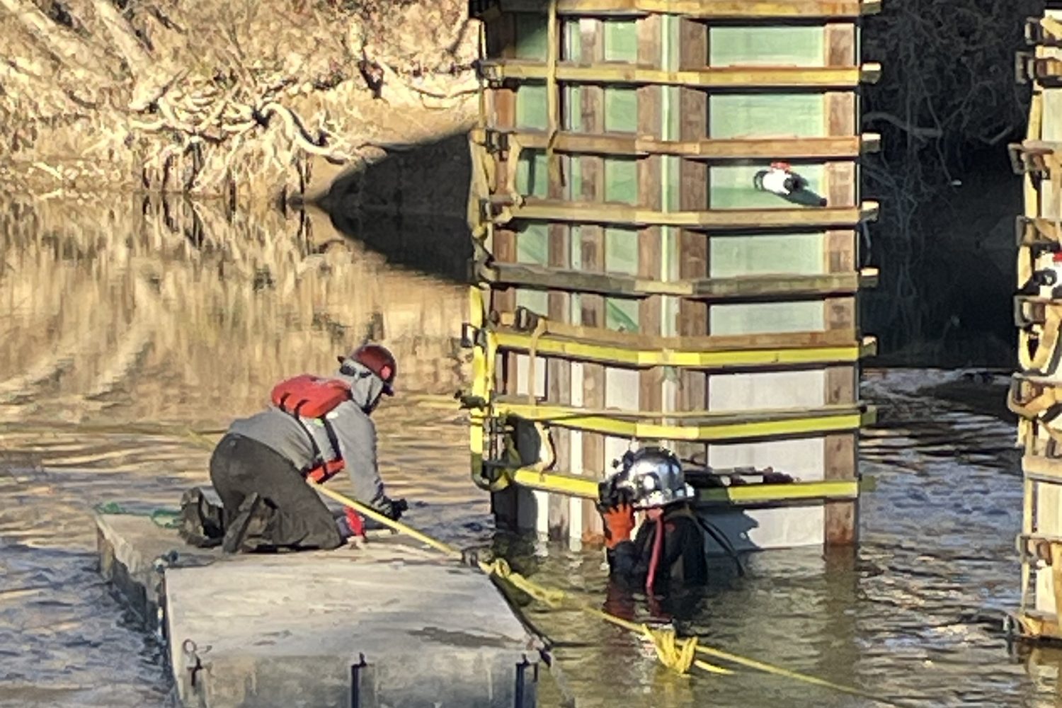 Commercial diver working at a pier form on a bridge substructure.