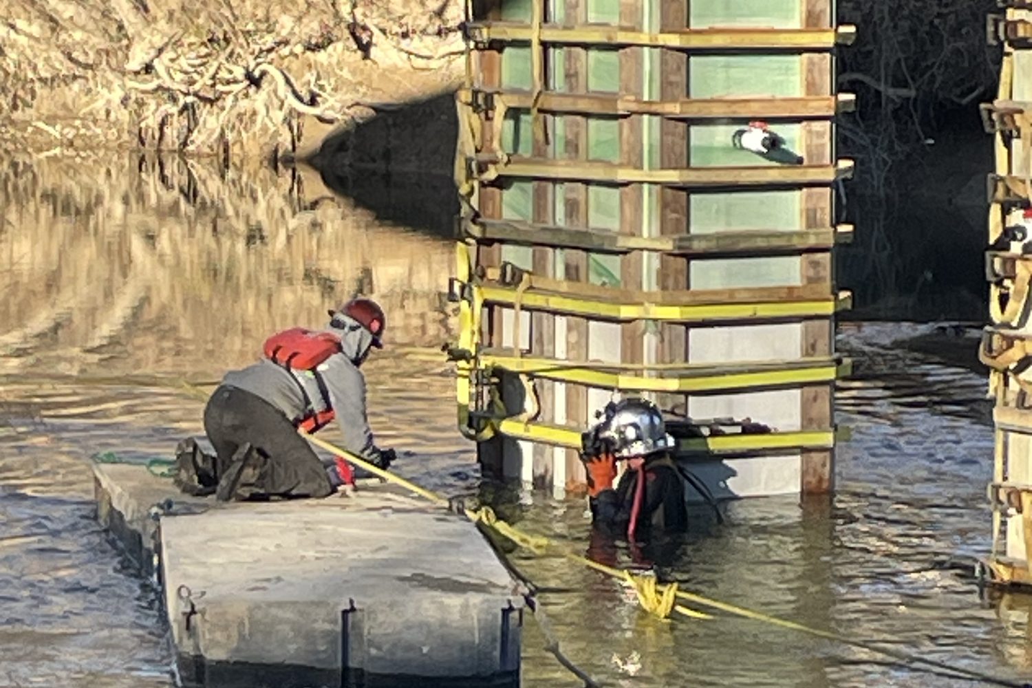 Diver at the jacket formwork beside a floating platform.