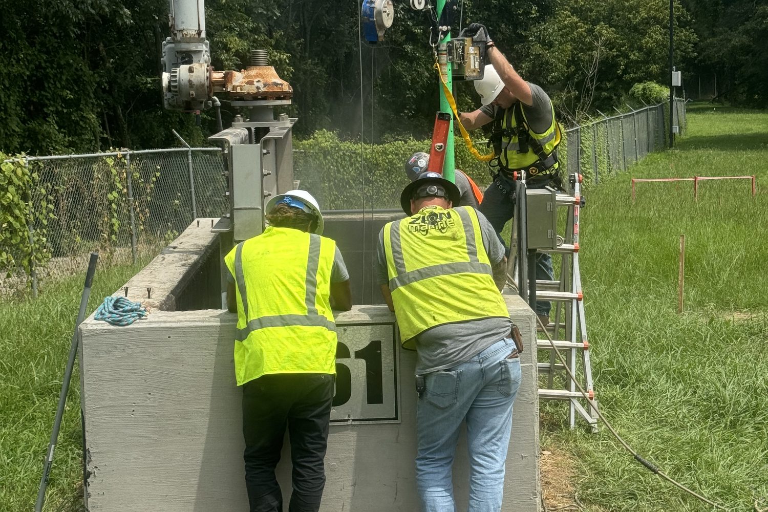 Crew working at a chlorine contact chamber at the R.M. Clayton water plant.