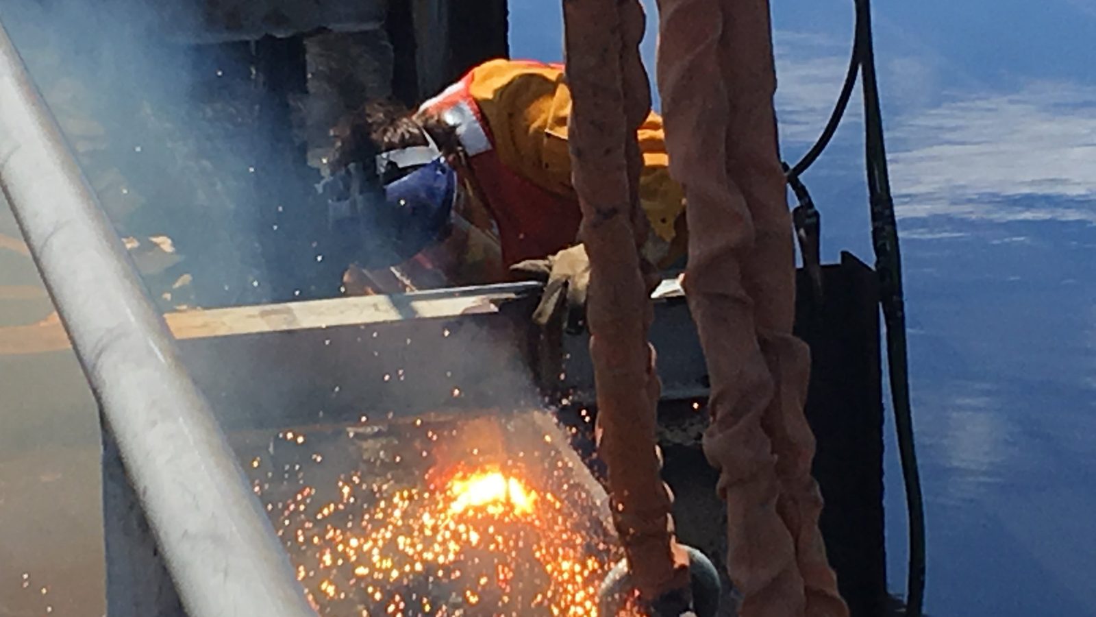 Cutting steel with a torch.
