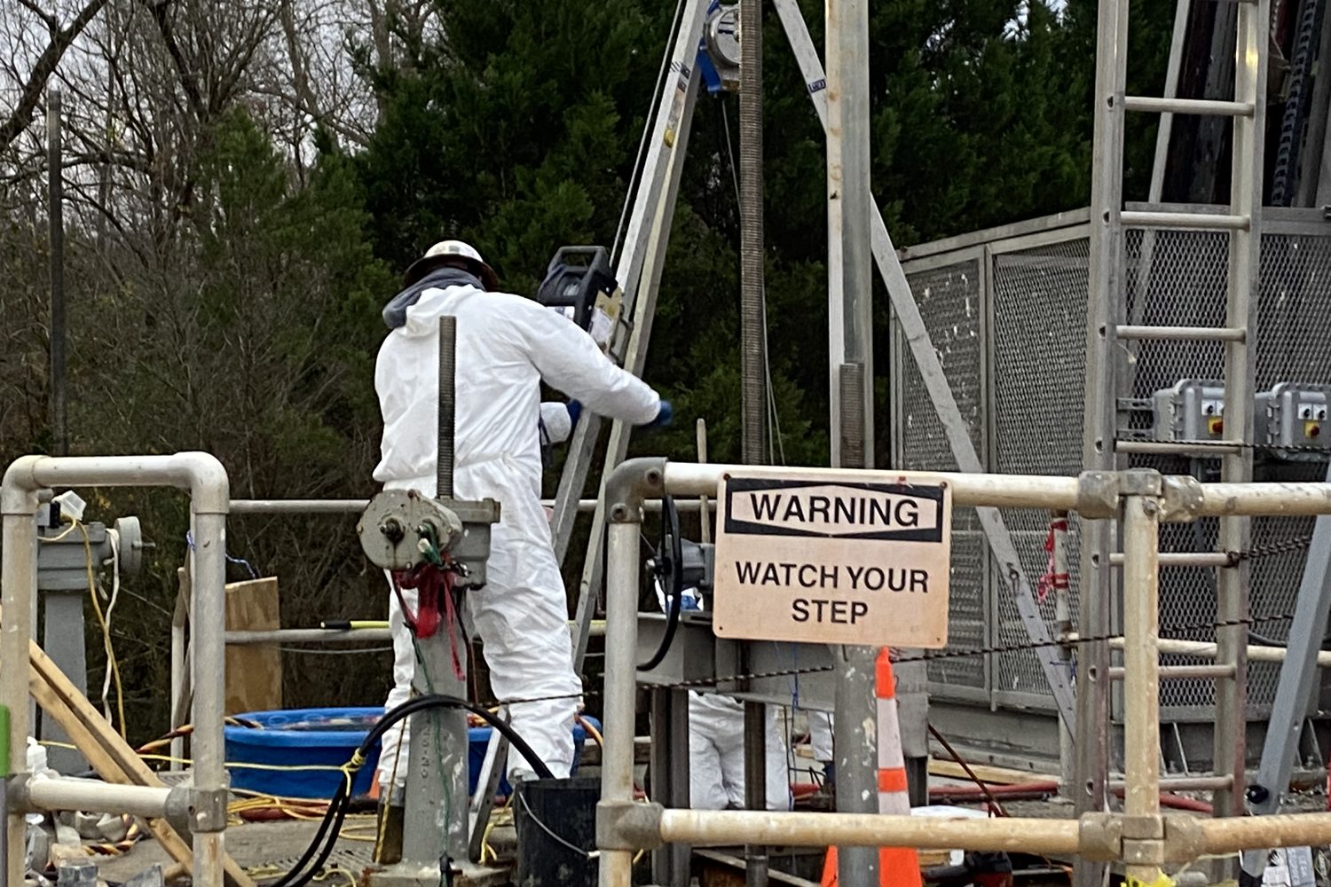 Crew in protective suits at a wastewater plant during a HAZMAT dive.