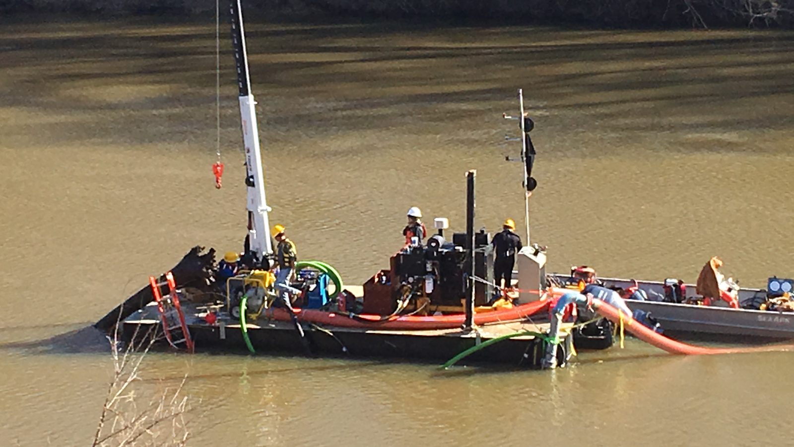 Dredge crew and barge at a water intake.