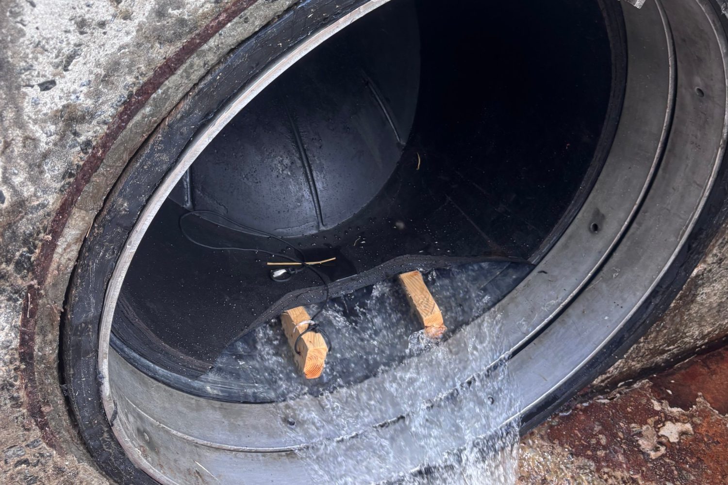 Duckbill check valve discharging at a levee outlet.