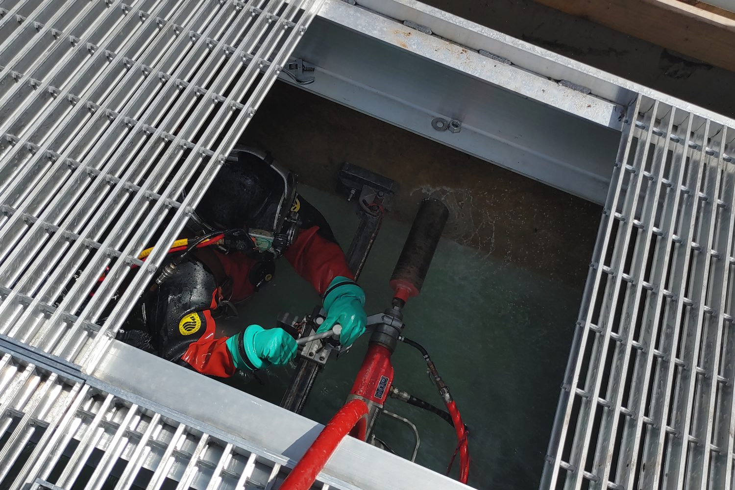 Diver working in a grated vault at a treatment plant.