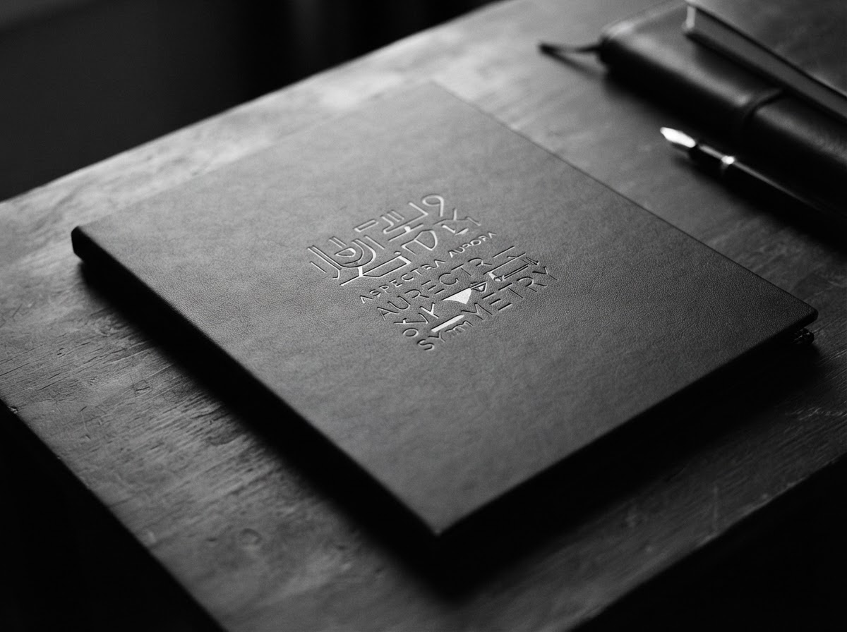 A matte-black Physical Capital Portfolio with minimal white typography