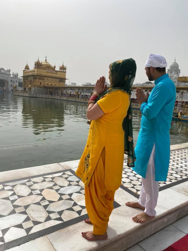 Ayesha and her husband offering prayers in reverent devotion at the Golden Temple in Amritsar