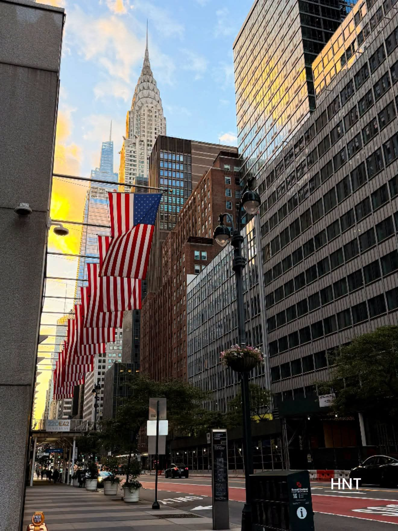 New York City street with American flags and the Chrysler Building