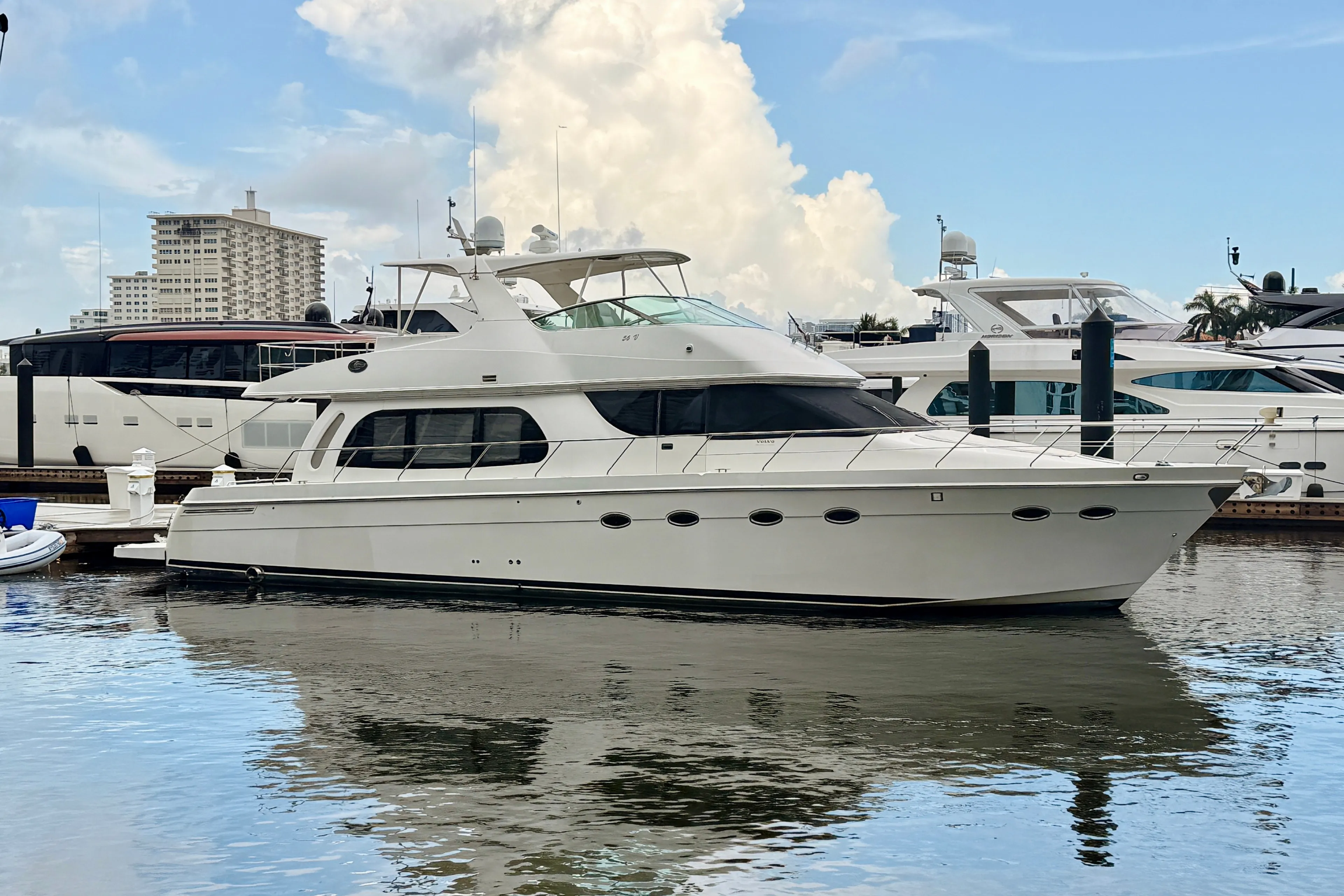 A 2005 Carver Pilothouse motor yacht cruising through deep blue water at golden hour