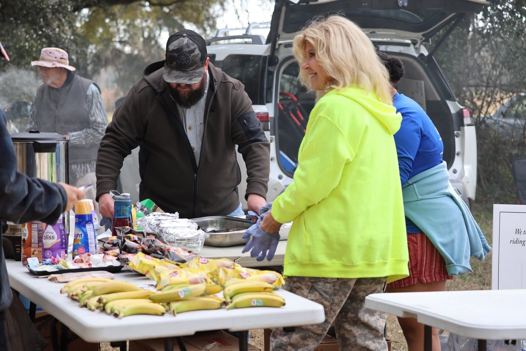 Volunteers setting up food and hospitality table at Hooves to Freedom