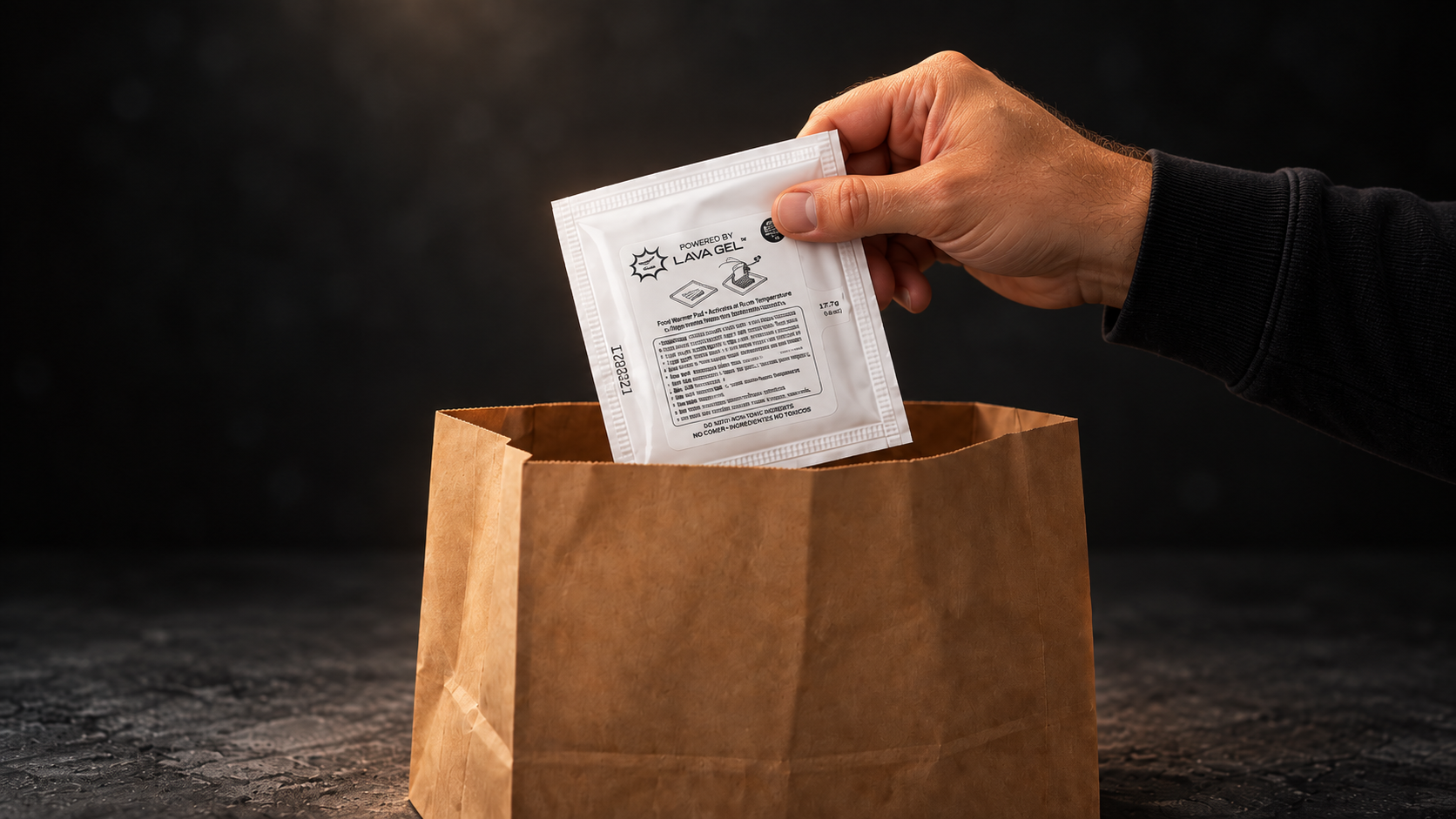 Hand placing sealed Lava Gel Delivery Pad into a restaurant delivery bag