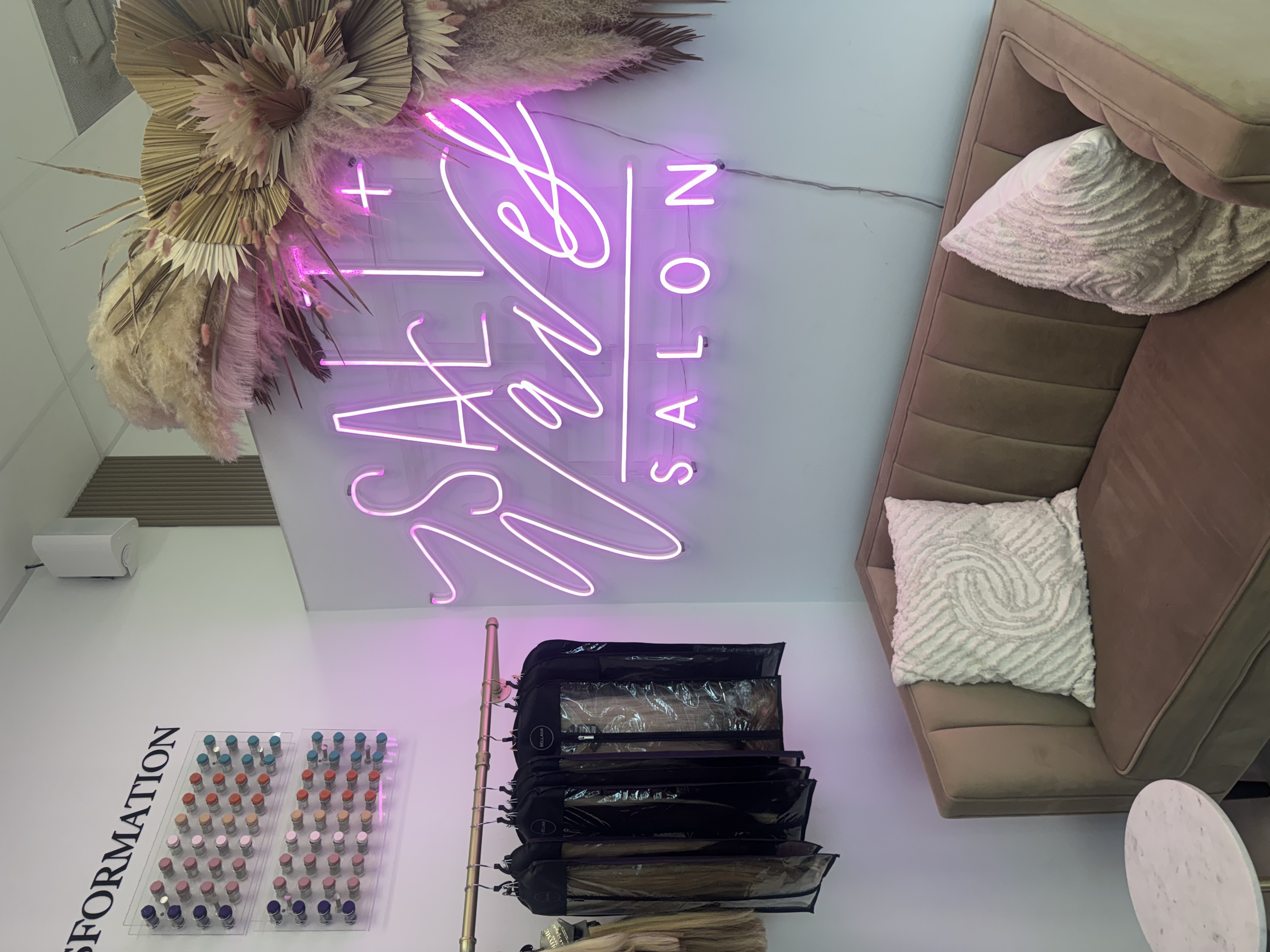 Salt + Waves Salon neon sign and lounge area