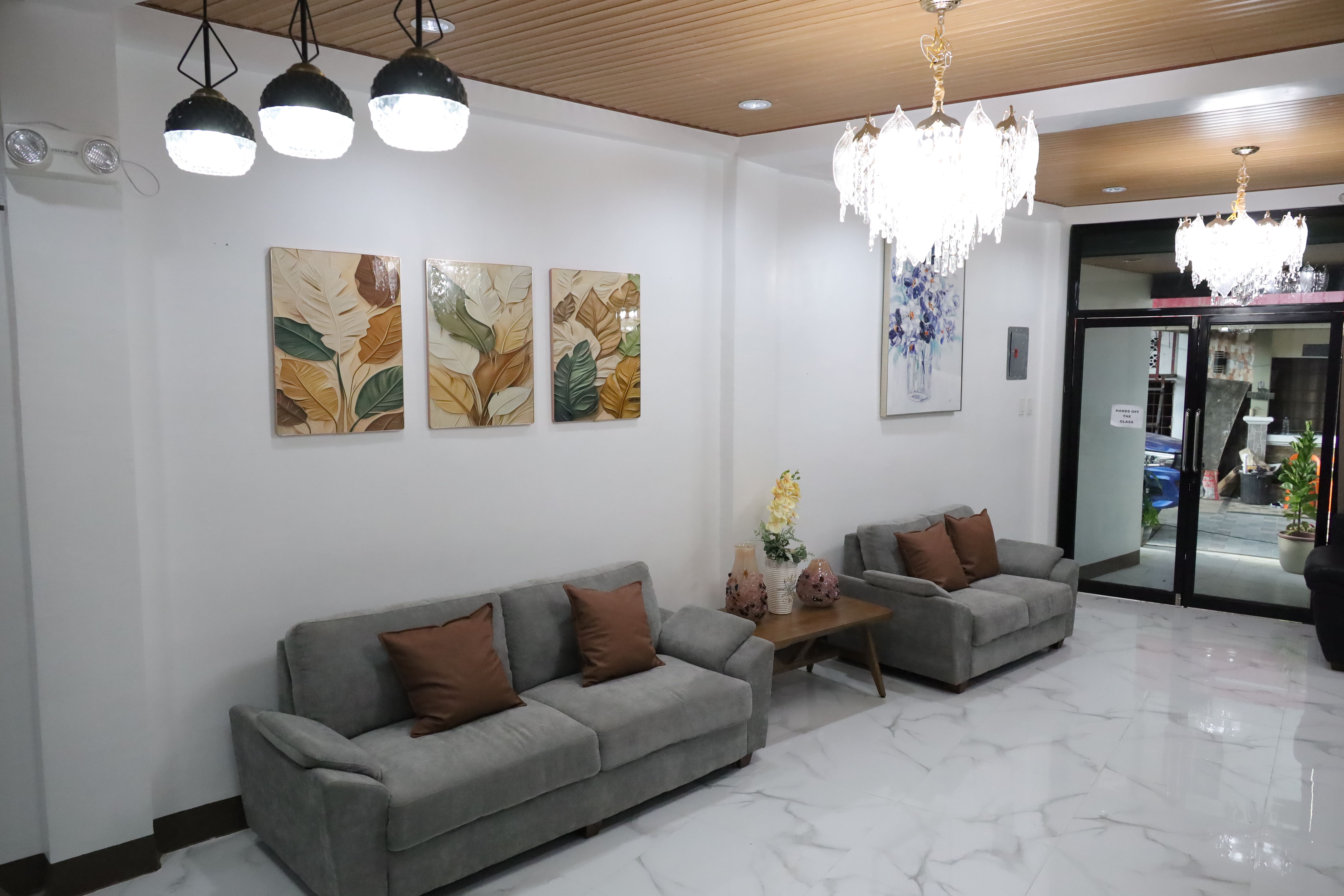 Guest lounge seating with cozy sofas and wall art in reception