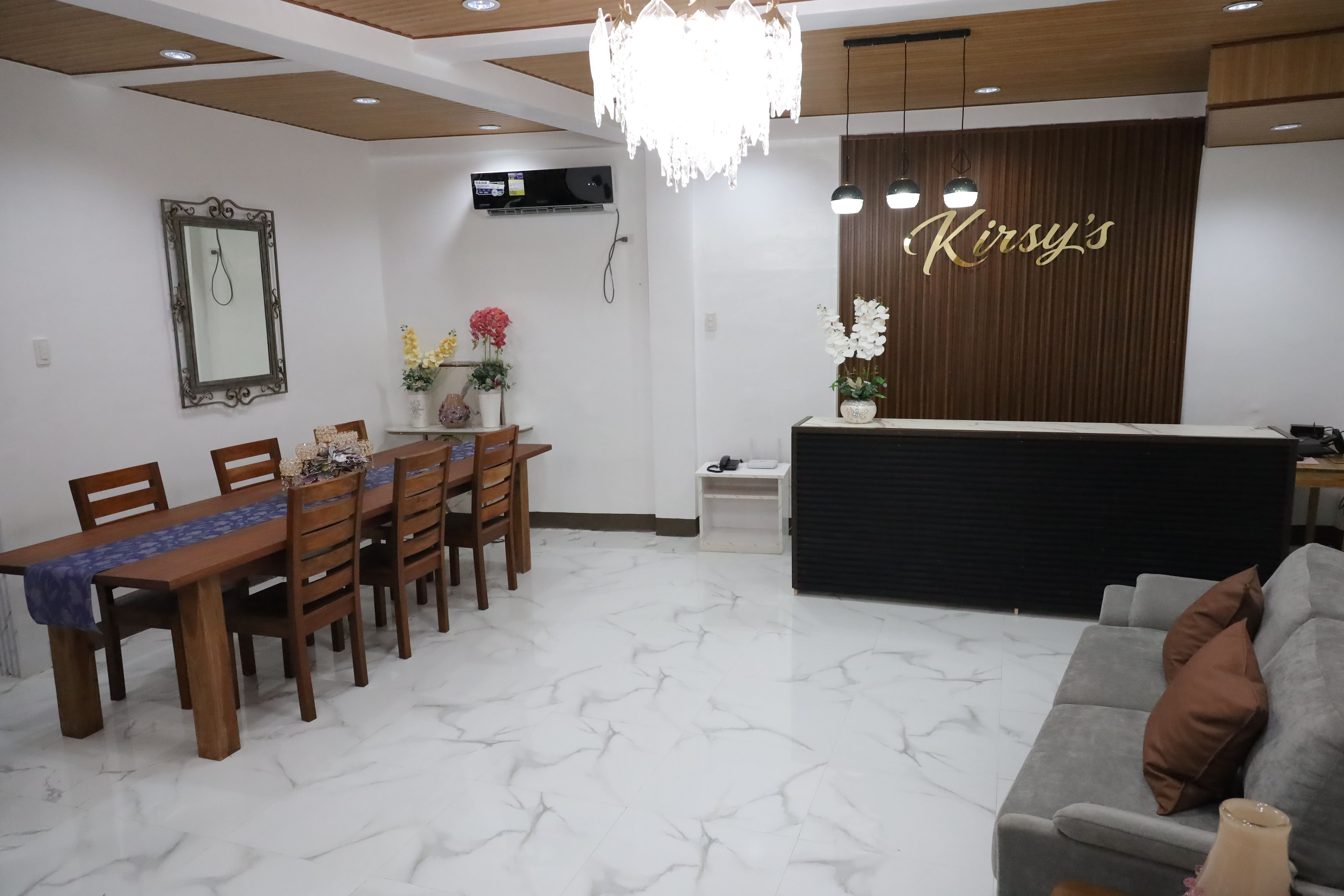 Bright reception lobby with wooden dining table and chandelier