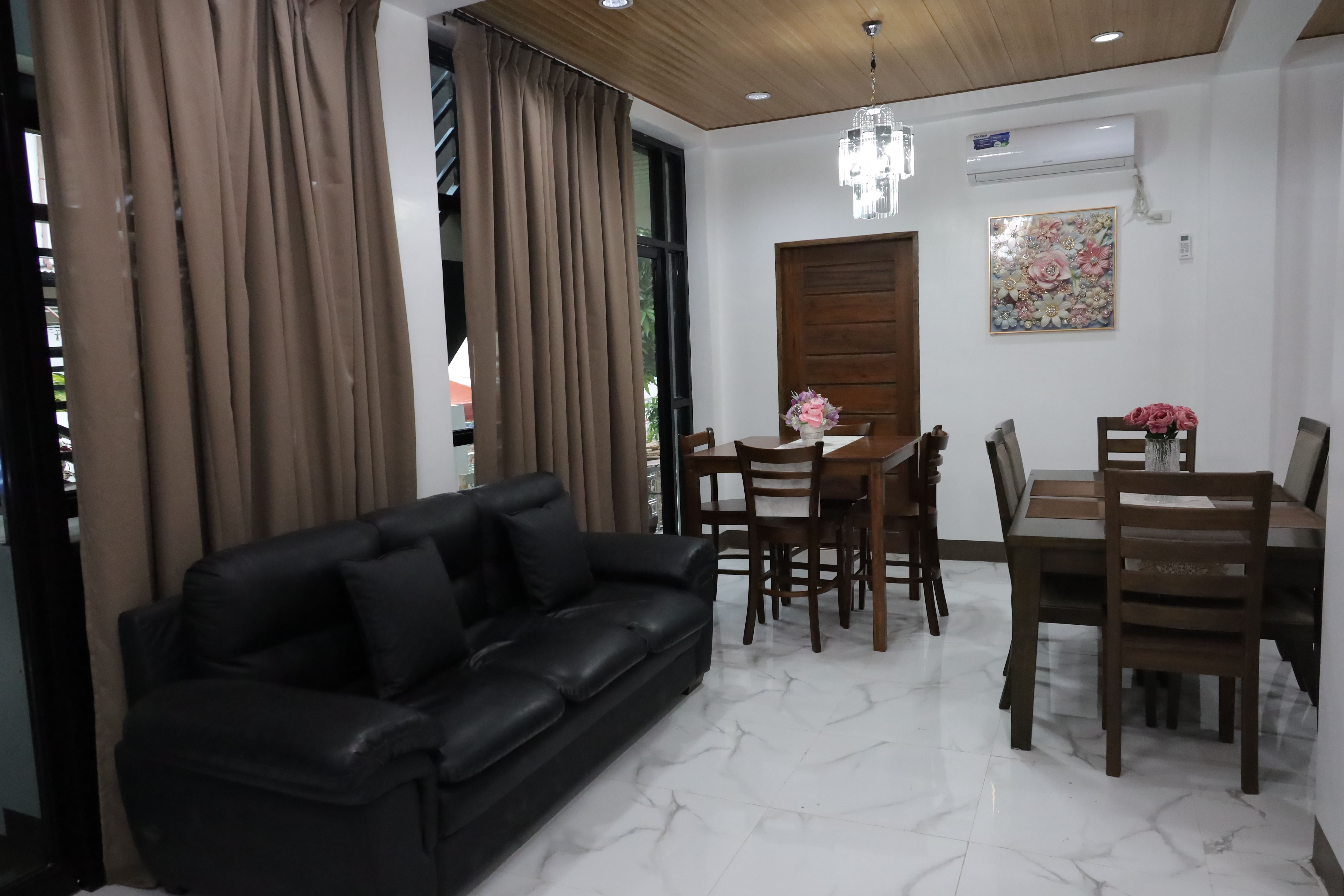 Reception lounge area with leather sofa and dining table