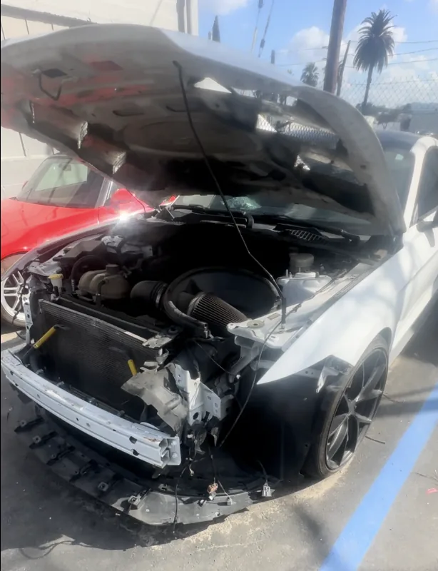 Ford Mustang front-end collision damage before repair at Focus On Cars Riverside