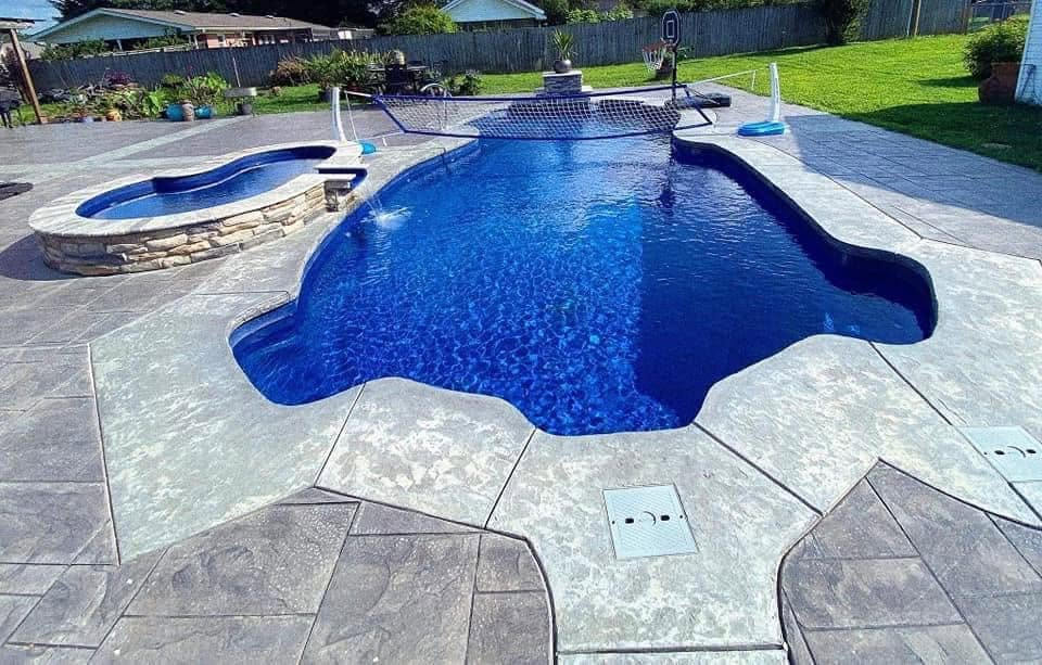 Completed Freeform Pool with Integrated Spillover Spa & Stamped Concrete