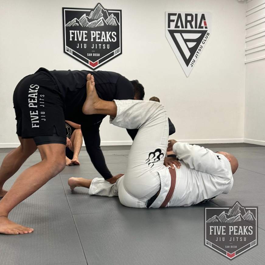 Five Peaks coach demonstrating open guard passing technique during private instruction on the mat