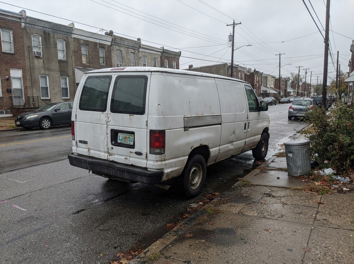 Plumber's van, dull phone photo, before professional visuals