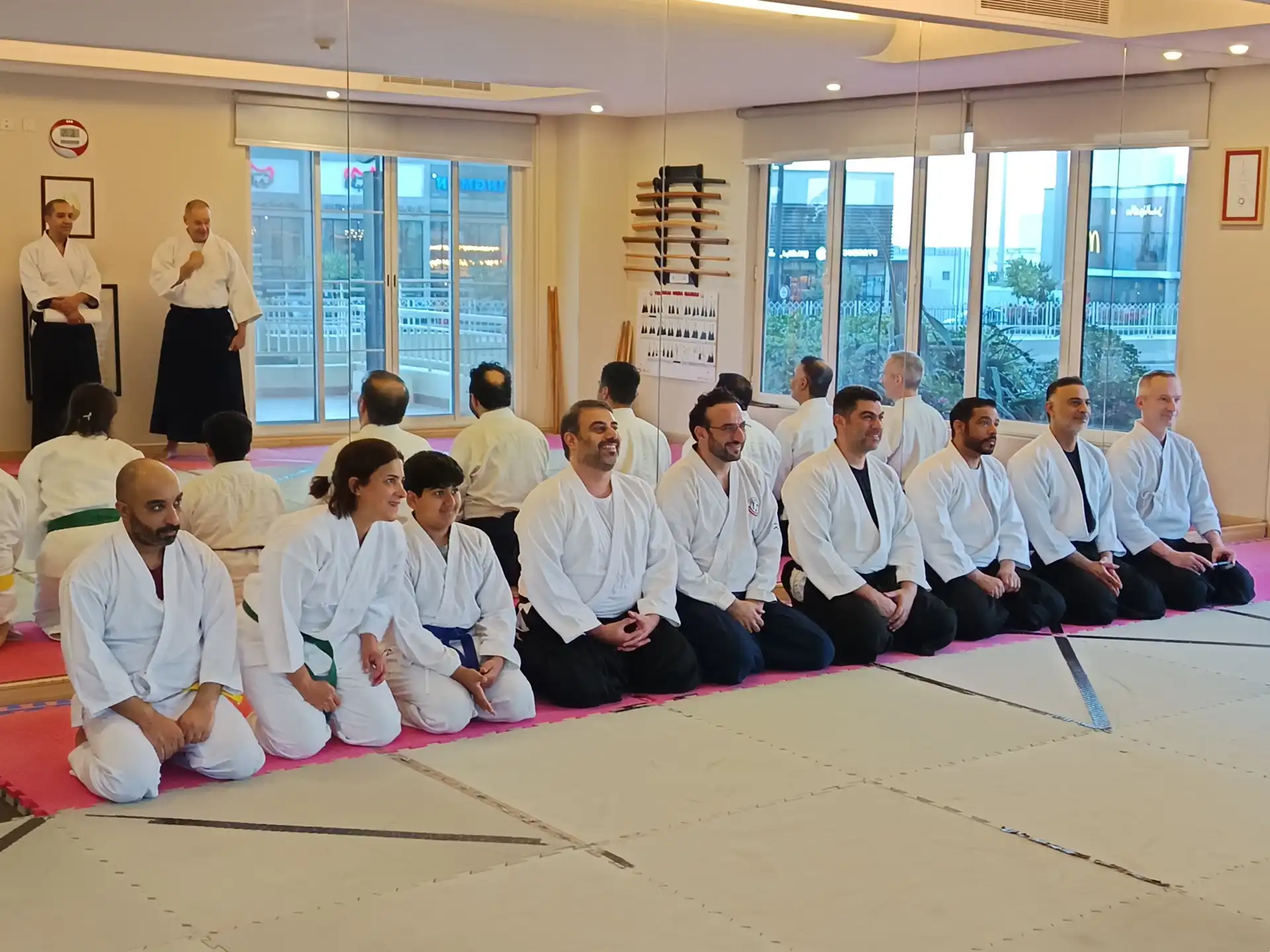 Aikido students kneeling in seiza in the dojo